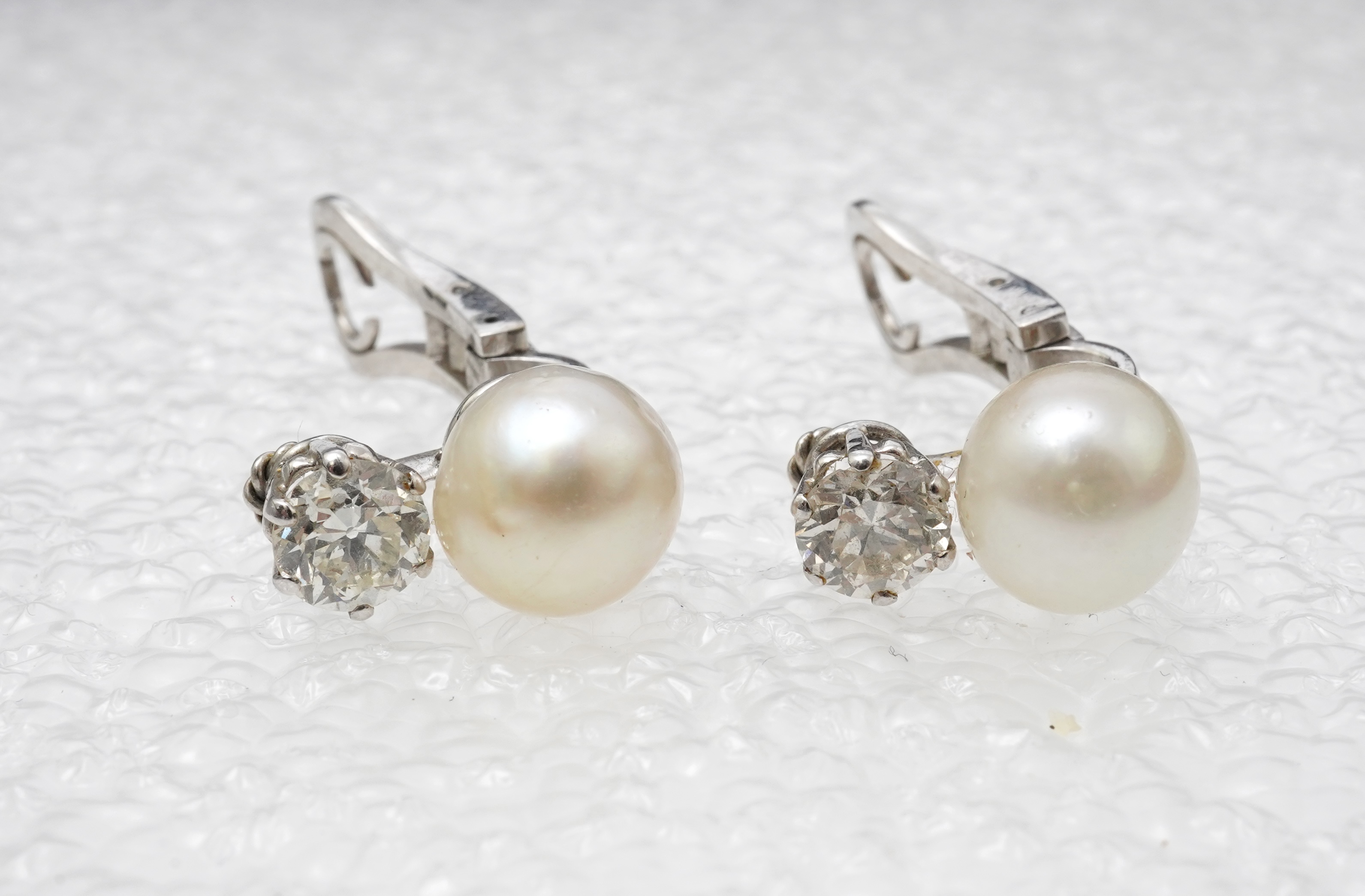 A pair of pearl and diamond ear clips, mid 20th century